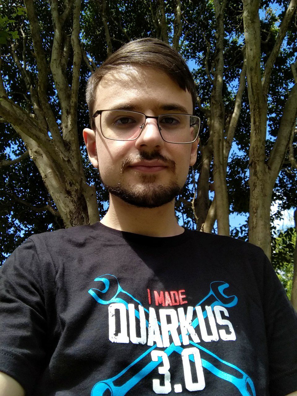 Me wearing Red Hat's 'I Made Quarkus 3.0' T-Shirt